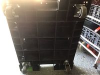 Bottom view showing four swivel caster wheels attached to plastic platform dolly