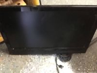 Black Dynex TV front view showing screen and Dynex branding below screen.