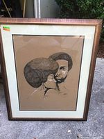 Framed signed print showing the portrait of a man and woman with afro hairstyles