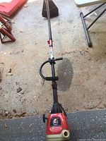 Full length view of the Troy Bilt TB70SS string trimmer showing shaft, handle, and trimmer head.