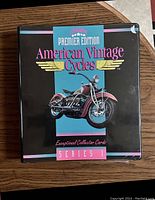 Black binder labeled 'Premier Edition American Vintage Cycles Exceptional Collector Cards Series 1' on cover showing a red vintage motorcycle image.