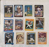 Front side of 12 vintage baseball cards showing players including Mark McGwire, Cal Ripken Jr., Jose Canseco, Reggie Jackson and others.