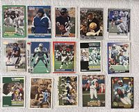 Front side of 16 football cards showing players including Troy Aikman, Barry Sanders, Phil Simms, Herschel Walker, Ed McCaffrey, Todd Lyght, Dan Marino, and others.
