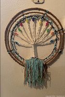 Close-up and full view of macramé tree wall hanging showing rope frame and bead details