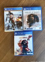 Front covers of three PS4 game cases: Battlefield 4, House of Ashes, and Star Wars Squadrons.
