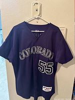Front side of the jersey showing 'COLORADO' and number 55 in white with black outline on purple fabric.