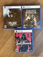 Front of three PS5 game cases: Resident Evil Village, Dead Space, and Ghostrunner.