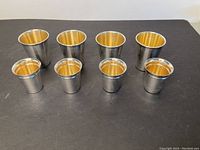 Front view of all eight beakers arranged in two rows