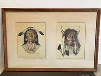 Full view of two framed Native American prints side by side within a wooden frame and matting.