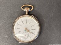 Front view of enamel dial with Roman numerals, decorative gold-tone hands and painted floral motif
