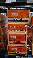 Stacked Lionel boxes showing labels for all four included items