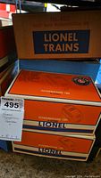 Two Lionel Powerhouse 180 transformer boxes and a Lionel No.460 Piggy Back Transportation Set box on shelf
