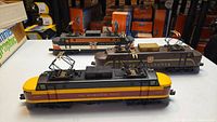 All three Lionel electric locomotives side by side on white tabletop: front Milwaukee Road #2351, middle Pennsylvania Railroad #2352, back New Haven #2350