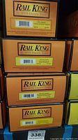 Stacked boxes showing RailKing by MTH Electric Trains branding with visible product details and item numbers