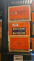 Stack of three Lionel Electric Trains boxes with labels visible for each distinct model train item.