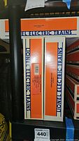 Photo showing three boxes of Lionel Electric Trains milk cars stacked showing labels with model numbers 19810, 9220, and 19818.