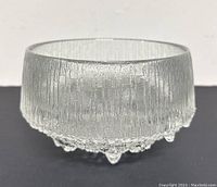 Clear textured footed glass serving bowl by Iittala, Finland, designed by Tapio Wirkkala. Textured vertical striations on upper rim and bubbled footed base mimicking melting ice.