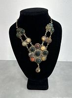 Full view of the assembled necklace displayed on black bust, showing all agate stones and chain.