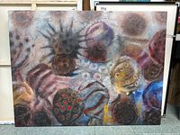 Full view of unframed abstract painting on canvas showing organic shapes and varied colors.