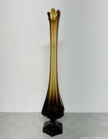 Full view of tall smoke brown Viking glass vase, showing elongated shape and flared scalloped mouth.