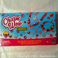 Front of box showing Charm Wow branding, colorful beads, and jewelry pieces made, highlighting 88-piece set including 2 necklaces and 2 bracelets.