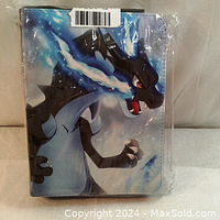 Front of card holder binder featuring Charizard artwork on the cover, shrink-wrapped in plastic, showing new condition.