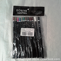 View of 12 BONIYA eye liner pencils side by side in unopened plastic bag, showing packaging and pencils with different cap colors.