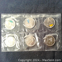 Sealed 6-pack of 2011 Canadian nature-themed quarter coins featuring partial color paint on three coins.