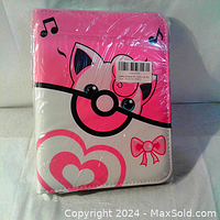 Front view of the new Pokemon card binder with pink Jigglypuff design wrapped in plastic.
