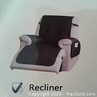 Photo of the dark gray quilted recliner slip cover shown installed on a recliner chair illustrating full coverage and side pockets.
