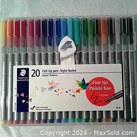 Set of 20 STAEDTLER triplus fineliner pens in storage box showing multiple vibrant colors and packaging label.
