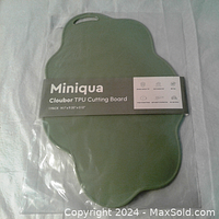 Photo of new packaged Miniqua Cloubor TPU cutting board in green color showing brand and product line on label.