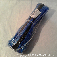 Blue coiled synthetic winch rope packaged in clear plastic wrap.