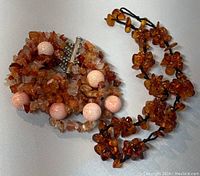 Bracelet and necklace shown together highlighting amber nuggets and pink beads on bracelet