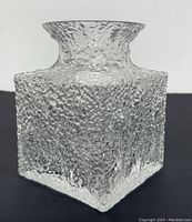 Front angle of textured clear glass vase showing square body and flared top opening