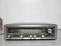 Front panel with tuning dial, controls, and power switch