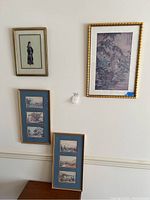 Four framed Asian art prints displayed on wall, shows relative sizes and frame styles.