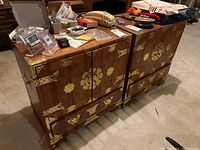 Front view of both side tables showing overall design, wood finish and brass hardware with miscellaneous items on top