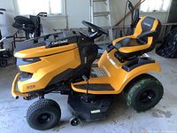 Side view of Cub Cadet riding mower showing 42-inch cutting deck, steering wheel, front and rear wheels