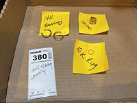 Photo shows all items with handwritten notes indicating 14K earrings, 10K ring, and sterling cufflink.