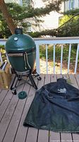 Grill, stand and cover on outdoor deck, view of grill and cover