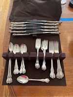 Tray of flatware in fabric case showing forks, spoons and long-handled spoons