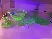 All ten pieces displayed under UV light on countertop