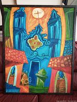 Front view of framed acrylic canvas painting showing cathedral architecture in abstract style, colors blue, orange, red, green with sun and cross.