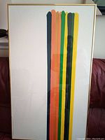 Full view of the framed Morris Louis Color Line print showing vertical colored stripes and the gold-colored frame.