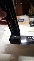 Diamond tester device above ring in box showing green indication