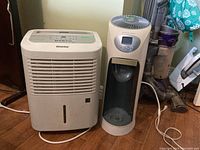 Photo showing Danby DDR4011 humidifier next to Bionaire BCM665 humidifier on floor