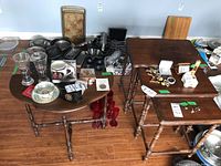 Photo showing the half moon side table and three nesting tables with various glassware and household items on and around the tables.