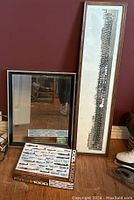 Beveled wall mirror, St Andrews corps photo, and aircraft puzzle puzzle box