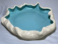 Overall view of the vintage Metlox Poppy Trail ceramic dish showing the blue interior and cream ruffled exterior rim.